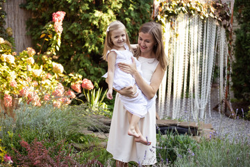 Naklejka premium mother and daughter having fun in garden, mother's day