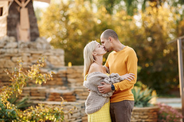 
couple in love, husband and wife hug and kiss, they are very happy together, are in nature summer or early autumn, good sunny weather