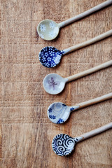 Empty ceramic spoons. Japanese handcrafted spoons. Rustic wooden background. Top view. 