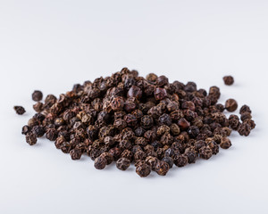 fragrant black pepper on white acrylic background