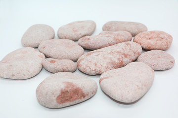 Fototapeta na wymiar Background - gray sea stones laid out on a white background