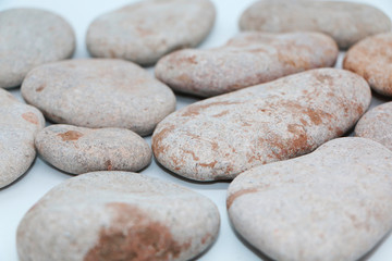 Background - gray sea stones laid out on a white background
