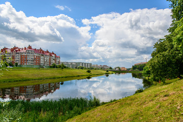 Fototapeta premium Reflection in a pond on the outskirts of the city