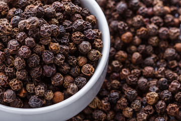 fragrant black pepper on white acrylic background