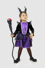 evil little girl witch in carnival halloween costume