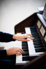 Fototapeta na wymiar pianist plays electric keyboard piano close up on hands