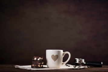 Coffee and utensils for coffee maker on dark brown background with copy space for text