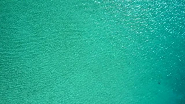 Bahamas, water ski and boat crossing the frame horizontally, drone shot
