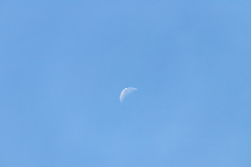 Crescent moon on blue sky.