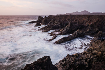 Fototapeta na wymiar Los Hervideros, coastline in Lanzarote with waves and volcano