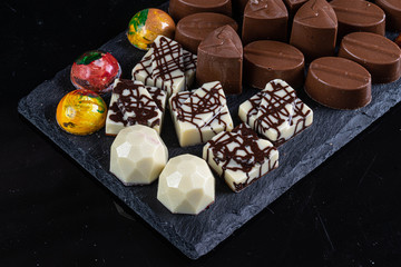 chocolate candies on black stone
