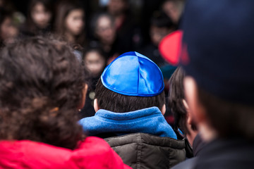 Jewish children gathering during a Stolpersteine memorial ceremony.	