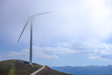 windmills at the top of a mountain whith blue sky