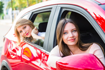 Girls going on road trip by car on summer day