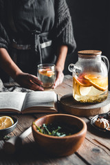 Woman cooks in a vintage kitchen on wooden tablet. Healthy drink, Eco, vegan.