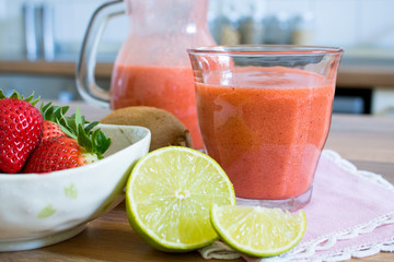 Food photography of a strawberry kiwi and lime smoothie