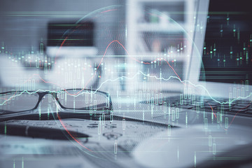 Financial chart hologram with glasses on the table background. Concept of business. Double exposure.