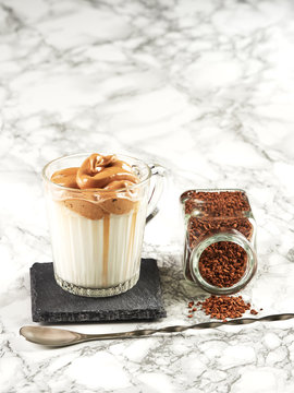 Dalgona Coffee: a layered drink made of hot milk and whipped instant coffee