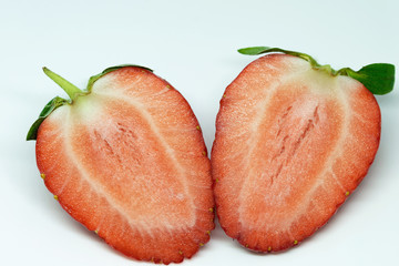 Strawberry in close-up. Red, ripe fruit on a white background. Spring natural food. The first spring delicacies.