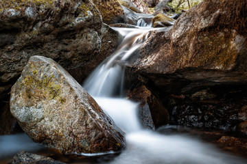 Naklejka na ściany i meble Mountain stream and boulders in Corsican forest