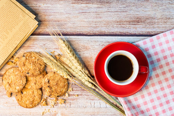 Coffee in a red cup and oatmeal cookies