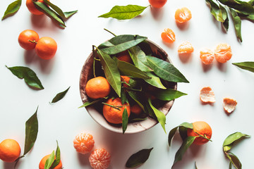 Tangerines on circle plate and white background