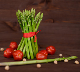 Bunch of asparagus with red tomatoes and chickpeas