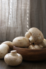 Champignon mushrooms in wood bowl