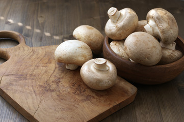 Champignon mushrooms in wood bowl
