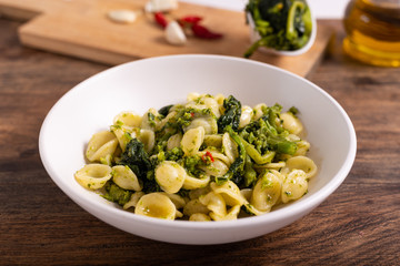 Typical dish of Italian cuisine, orecchiette with turnip greens. Orecchiette with cime di rapa, vegan food, healthy dish, fast lunch.