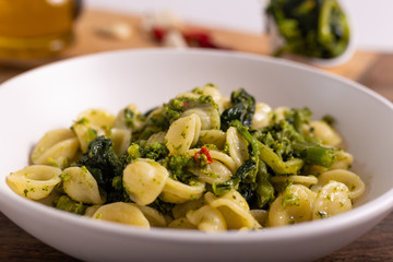 Typical dish of Italian cuisine, orecchiette with turnip greens. Orecchiette with cime di rapa, vegan food, healthy dish, fast lunch.