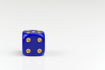 Four points on single blue dice isolated on white background
