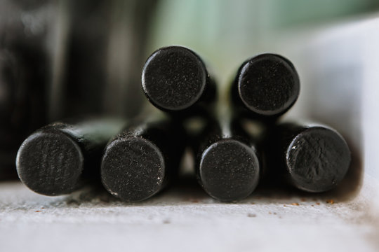 Round black ends of wooden sticks. The ends of the artificial skewers