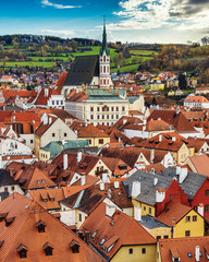 Rooftop view of Cesky Krumlov and high St Vitus church, famous touristic old town on Czech Republic