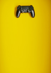 Video game competition. Gaming concept. Black joystick on yellow backround.