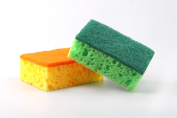 Two dishwashing sponges isolated on a white background.