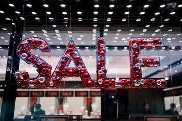 SALE sign on showcase display in shopping mall mading from christmas decoration.