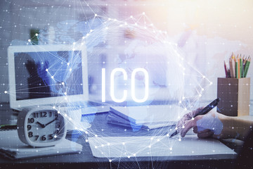 Cryptocurrency hologram over hands taking notes background. Concept of blockchain. Multi exposure