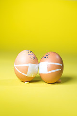 Easter eggs in masks are kissing each other on the date.