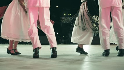 Traditional romanian folklore dancers in traditional costumes dancing on stage in slow motion	
