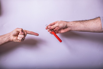 Hand holds a test tube containing a blood sample or other liquid, test tube with blood for Covid-19...