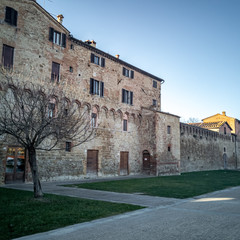 Fototapeta na wymiar Buonconvento, medieval village in Tuscany, Italy. Surrounded by walls built since 1371, it is part of the Crete Senesi and rises in the Ombrone Valley. Ancient walls seen from outside.
