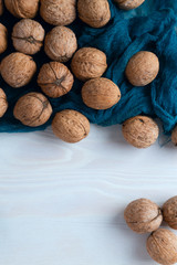 walnuts on a blue cloth and a wooden table