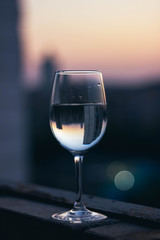 glass of water in the balcony in spring sunset