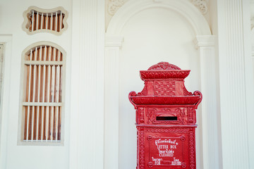 Ancient red mail box on street of Phuket, Thailand.