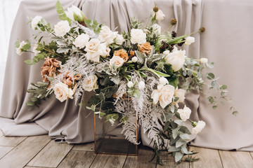 Stylish wedding floristics. Banquet tables decorated with arrangements of flowers, herbs and candles