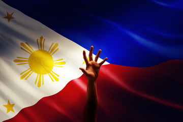 a raising hand in front of Philippines flag, idea, conceptual images.