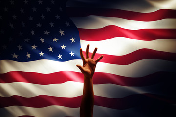 a raising hand in front of America flag, idea, conceptual images.