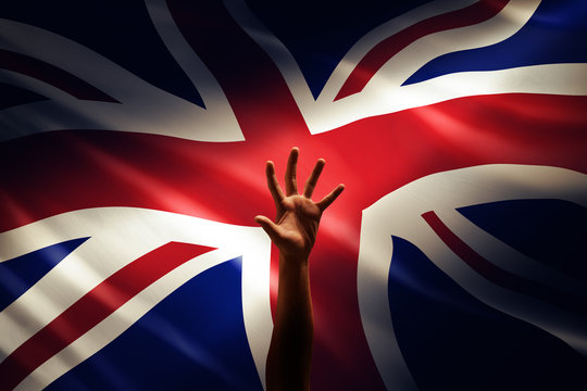 a raising hand in front of England flag, idea, conceptual images.