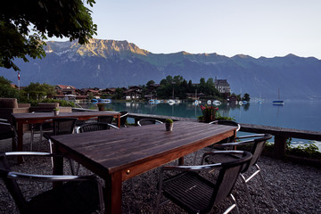 Wooden cafe tables on the bay of Brienz lake, Switzerland.